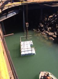 Lifting floating work platform into position
